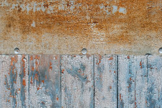 the door of planks covered with sheets of rusty metal, chipped old paint, which has long been under the influence of various climatic conditions