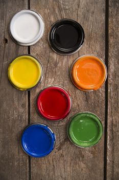 Presentation of a series of cans of paint of various colors
