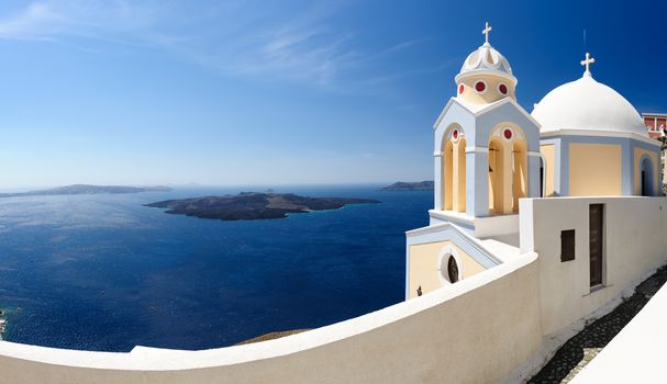 High resolution panorama view with orthodox church in Fira, Santorini, Greece. Lot of copyspace, 5 frames stitched.