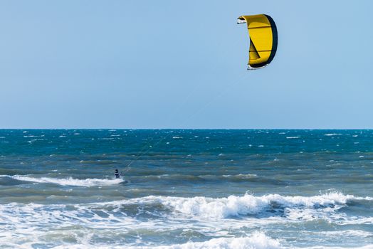 Kiteboarder enjoy surfing on a sunny day.