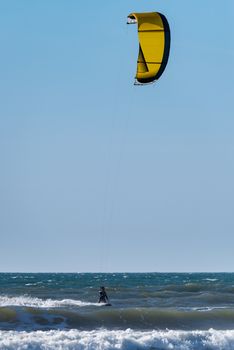 Kiteboarder enjoy surfing on a sunny day.