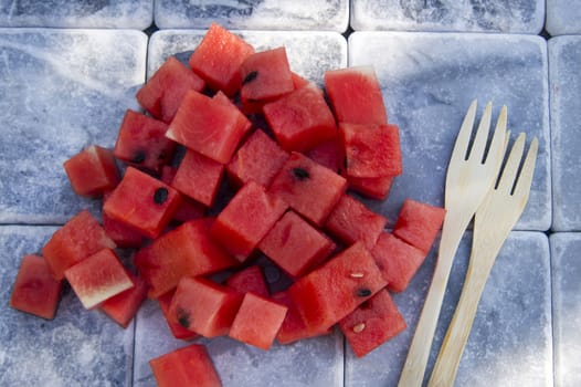 Presentation of a summer dish made of diced watermelon 