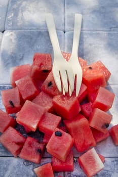 Presentation of a summer dish made of diced watermelon 