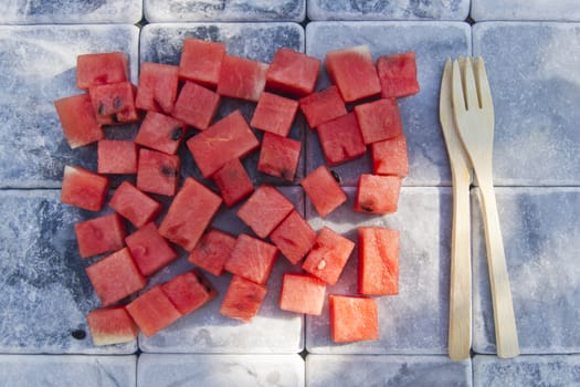 Presentation of a summer dish made of diced watermelon 