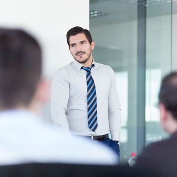 Relaxed team leader and business owner leading informal in-house business meeting. Business and entrepreneurship concept.