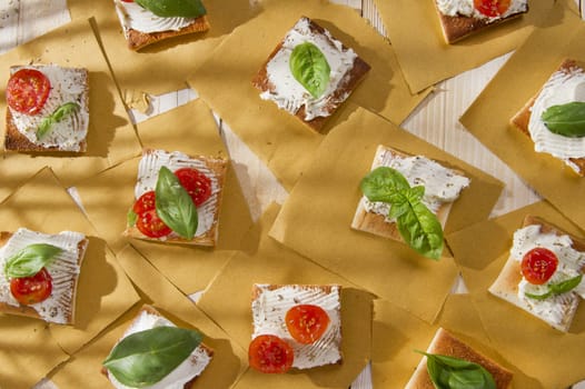 Tricolor cocktail canapes, cheese and tomato salad 