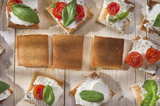 Tricolor cocktail canapes, cheese and tomato salad 