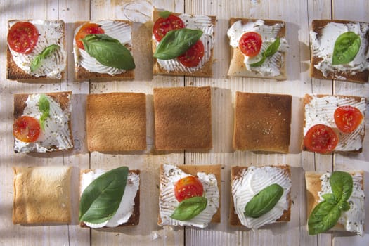 Tricolor cocktail canapes, cheese and tomato salad 