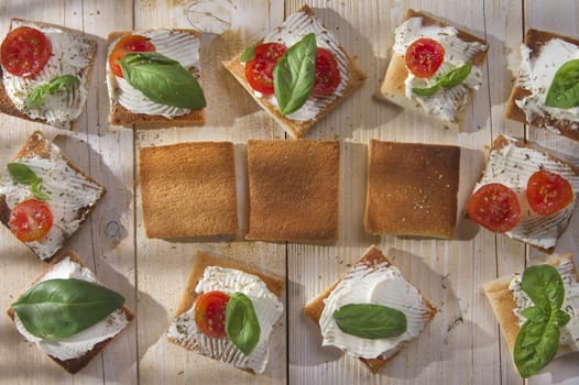 Tricolor cocktail canapes, cheese and tomato salad 