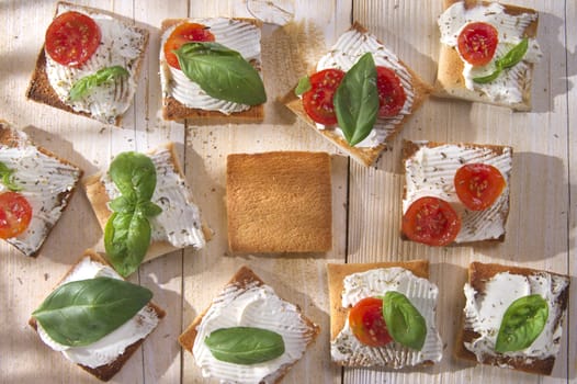 Tricolor cocktail canapes, cheese and tomato salad 