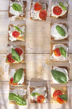 Tricolor cocktail canapes, cheese and tomato salad 