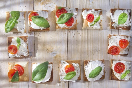 Tricolor cocktail canapes, cheese and tomato salad 