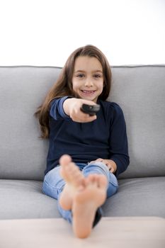 Little girl holding a TV remote control