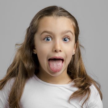 Portrait of a little girl with her tongue out