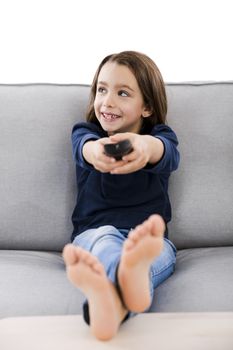 Little girl holding a TV remote control