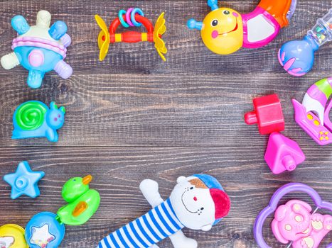 top view or flat lay on colorful toys on dark wooden background with copy space