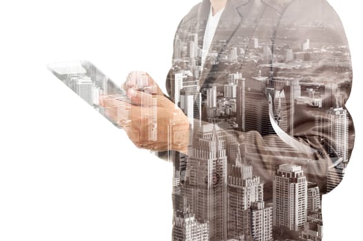 Double exposure of a businessman and a city using a tablet over white background