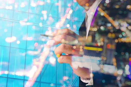 Double Exposure of Businessman writing with Building decorated with Glass