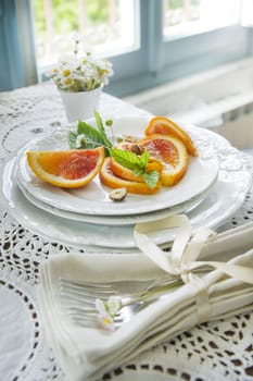 Presentation of fruit, slice of orange with almond 
