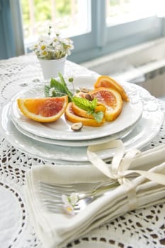 Presentation of fruit, slice of orange with almond 

