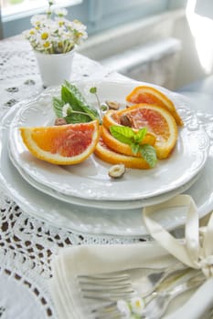 Presentation of fruit, slice of orange with almond 
