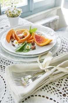 Presentation of fruit, slice of orange with almond 
