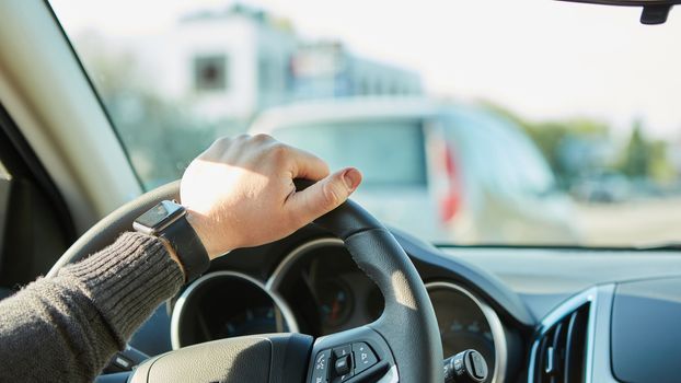 Closeup Of A Man Hands Holding Steering Wheel While Driving Car with retro filter effect