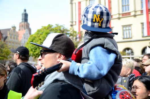 WROCLAW, POLAND - MAY 1: Unidentified young boy sits on his father arms with guitar and plays Hey Joe during Thanks Jimi Festival on 1st May 2016 in Wroclaw, Poland.