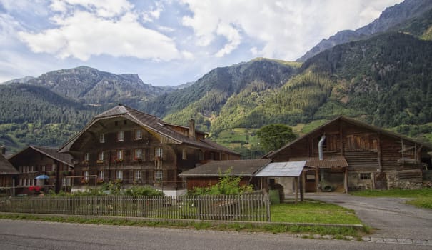Several chalets and trees in Swiss mountain