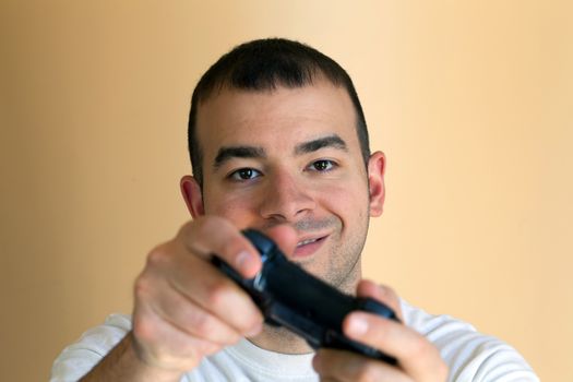 30 something video gamer gaming with his wireless controller.