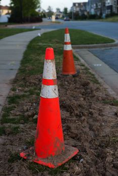 A dirty cone on a side walk at theend of the day
