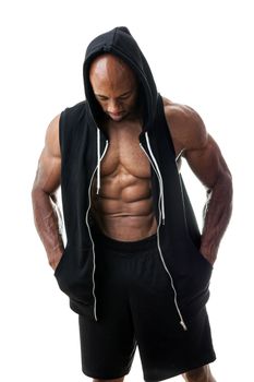 Toned and ripped lean muscle fitness man wearing a hooded sweatshirt isolated over a white background.