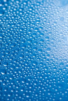 close-up of water drops on the blue background.