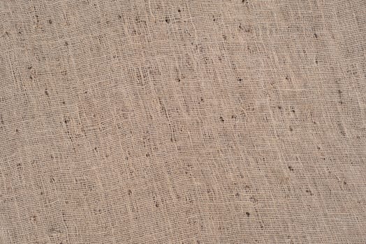 Close-up view of sackcloth texture with holes for background. 