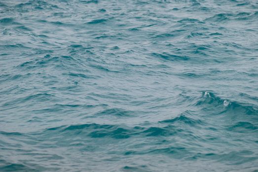 Photo closeup of beautiful clear turquoise sea ocean water surface with ripples low waves on seascape background. horizontal picture