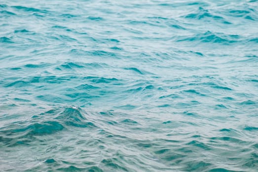 Photo closeup of beautiful clear turquoise sea ocean water surface with ripples low waves on seascape background. horizontal picture