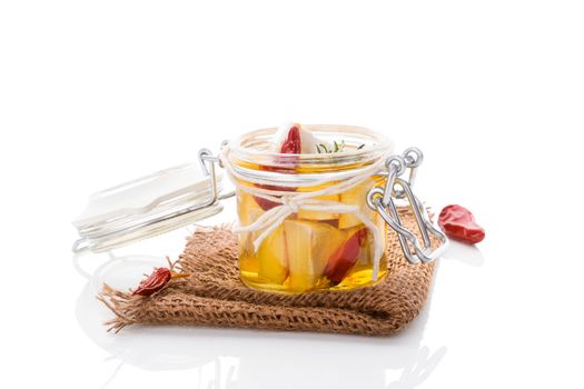 Marinated camembert cheese in glass jar isolated on white background. Culinary cheese eating. 