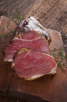 Traditional smoked meat on wooden table. Culinary meat eating. 