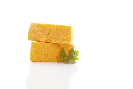 Delicious cheddar cheese isolated on white background. Culinary traditional cheese eating. 