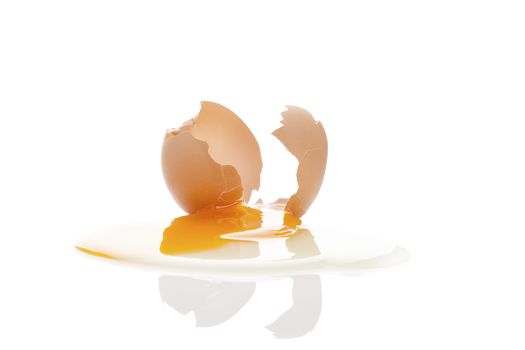 Broken chicken egg isolated on white background with reflection. 