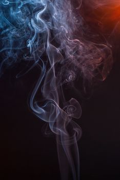 Beautiful smoke on the black background - macro photo.