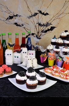 Table served with a variety of sweets and drinks on Halloween