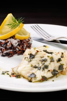 Slices of boiled fish with pesto and black, brown, white rice