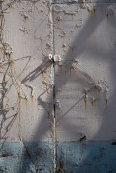 Rust rusty corroded oxidize colorful door used metal sheet plate pattern wallpaper crack grunge abstract aged background iron artistic wall flaking peeling paint.