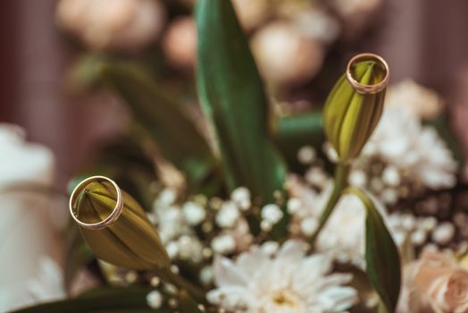 Wedding rings  laying on  bouquet. Macro shot.