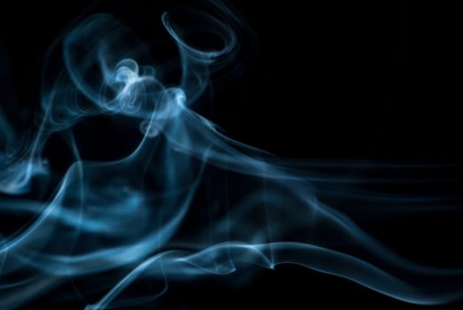 Beautiful smoke on the black background - macro photo.