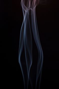 Beautiful smoke on the black background - macro photo.