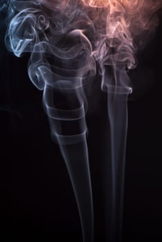 Beautiful smoke on the black background - macro photo.