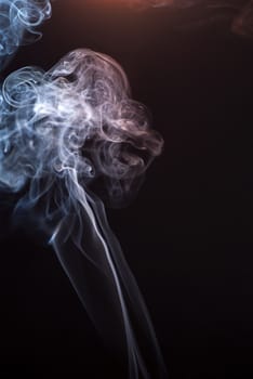 Beautiful smoke on the black background - macro photo.