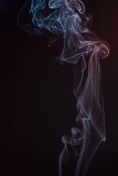 Beautiful smoke on the black background - macro photo.